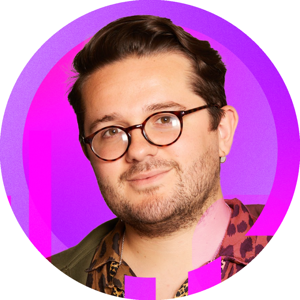 Will Hobson, a white man wearing glasses smiling softly towards the camera.